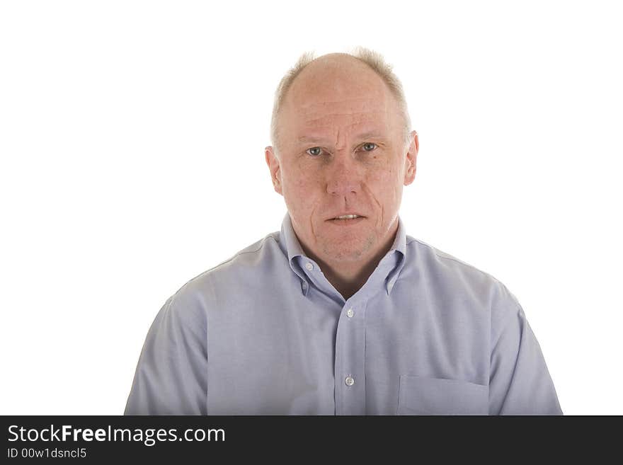 An older guy in a blue dress shirt looking serious. An older guy in a blue dress shirt looking serious