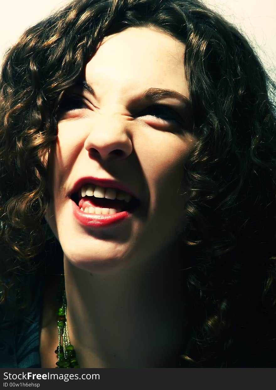 A portrait about a pretty lady with white skin and long brown wavy hair who is shouting. A portrait about a pretty lady with white skin and long brown wavy hair who is shouting