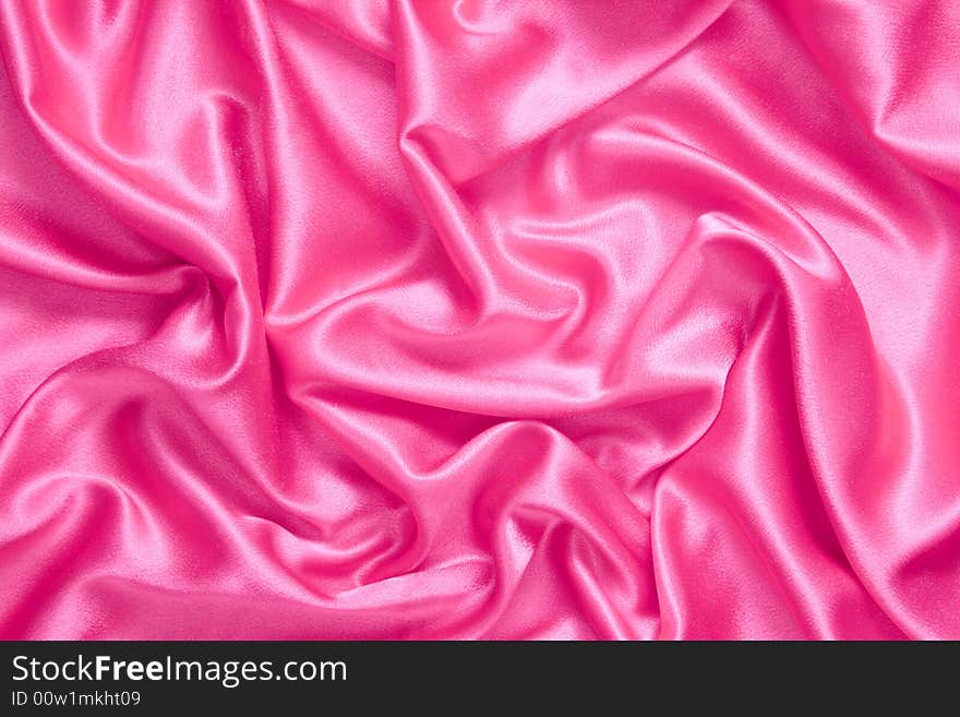 Background. Pink satin fabric with folds. Background. Pink satin fabric with folds