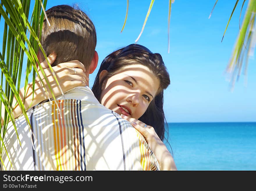 A portrait of attractive couple having date on the beach. A portrait of attractive couple having date on the beach