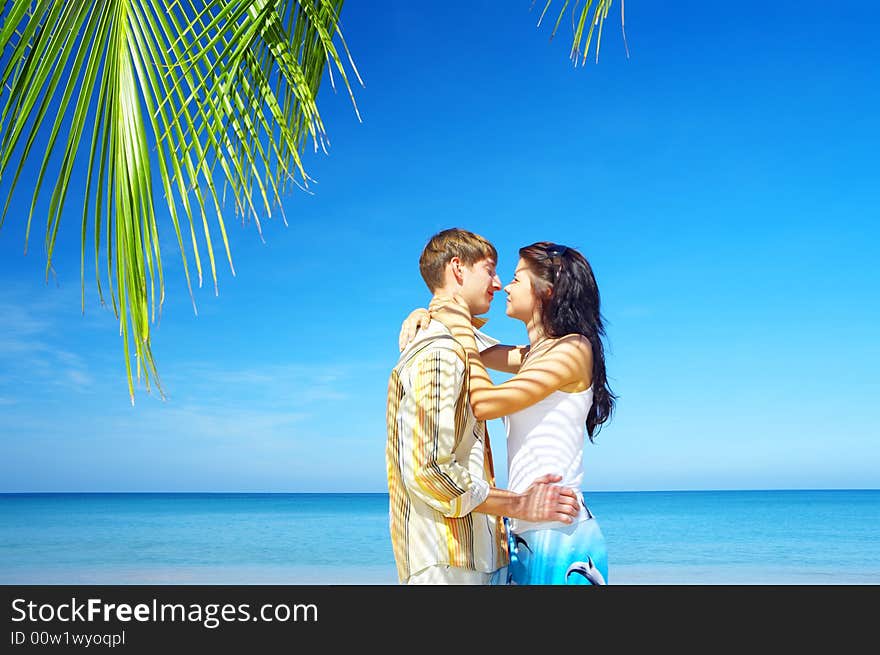 A portrait of attractive couple having date on the beach. A portrait of attractive couple having date on the beach