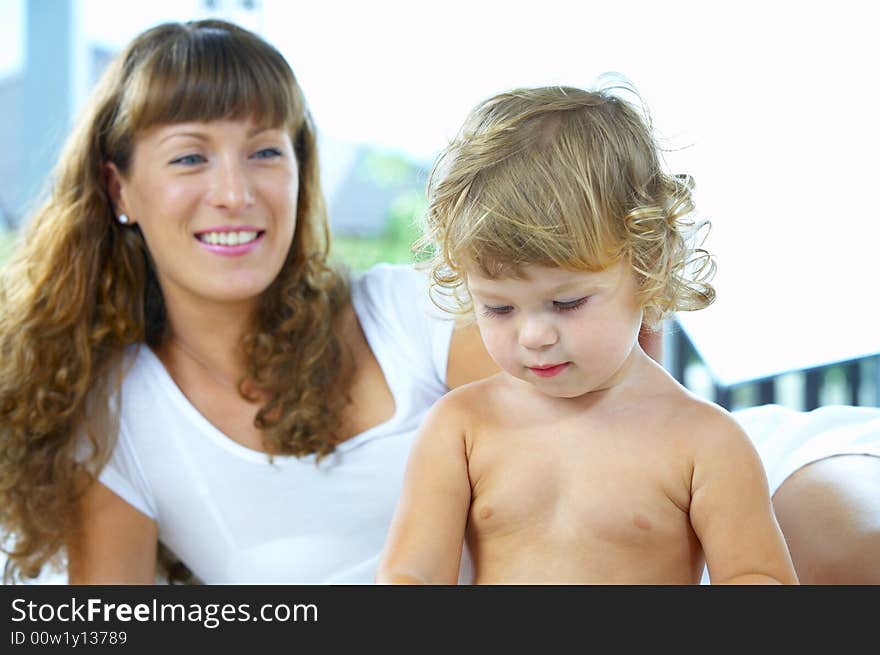 High key portrait of happy mother with baby. High key portrait of happy mother with baby