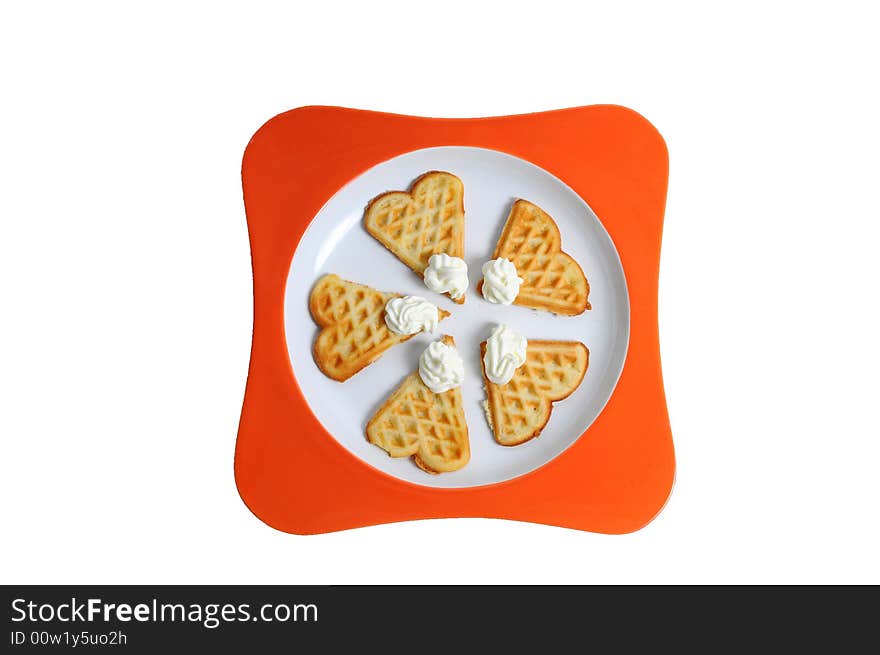 Tasty waffles with whipped cream on a plate. Tasty waffles with whipped cream on a plate