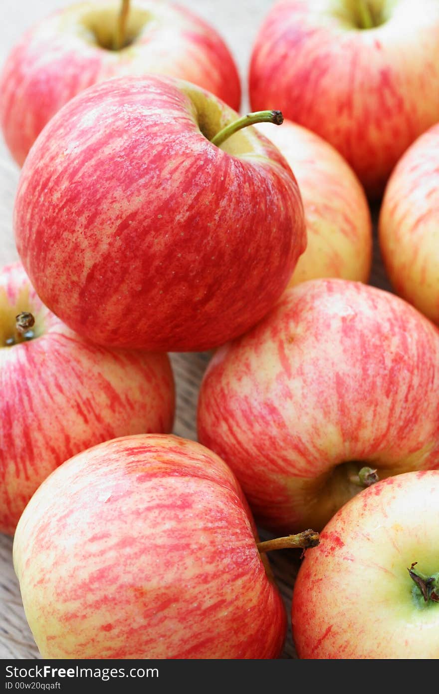 Pile of freshly picked juicy red apples stacked on top of each other