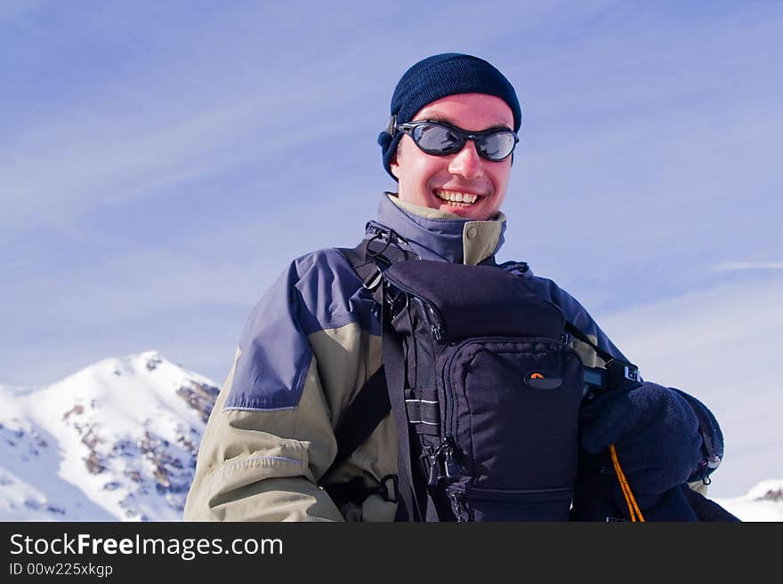 Glad man on background of the mountains.