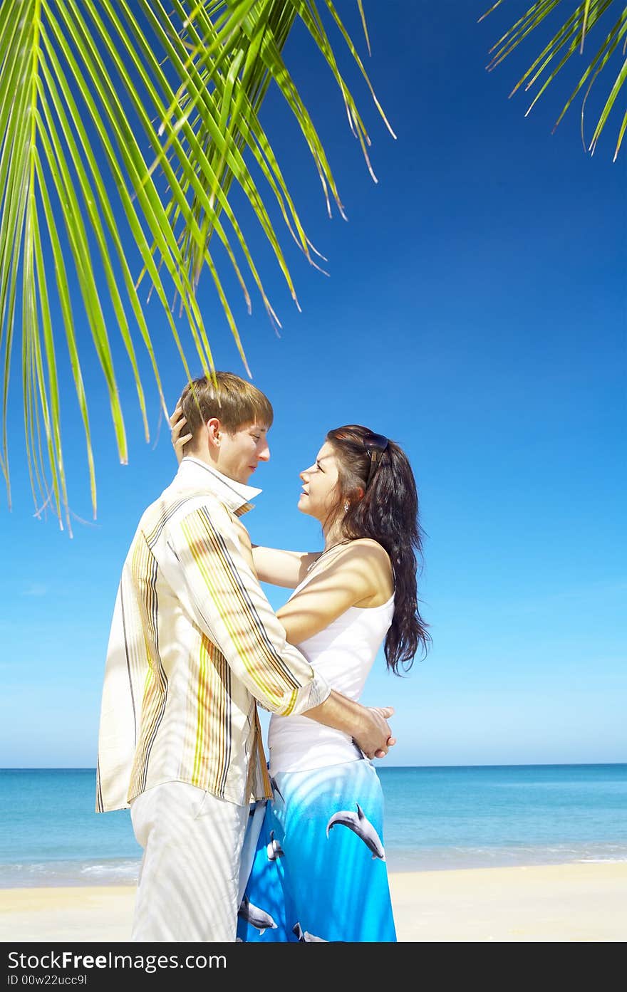 A portrait of attractive couple having date on the beach. A portrait of attractive couple having date on the beach