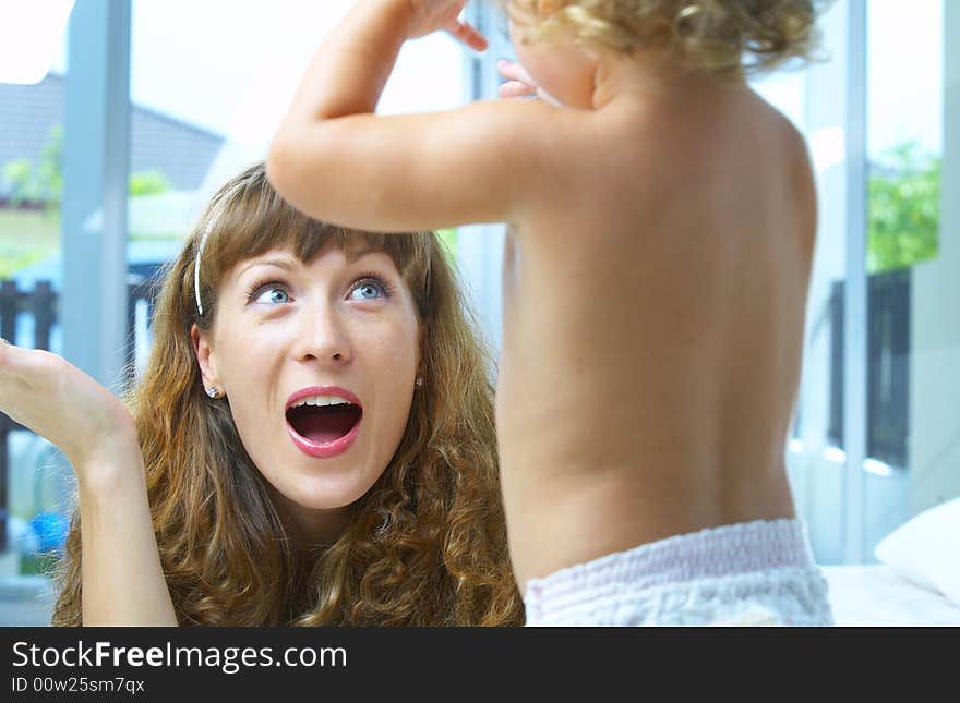 High key portrait of happy mother with baby. High key portrait of happy mother with baby