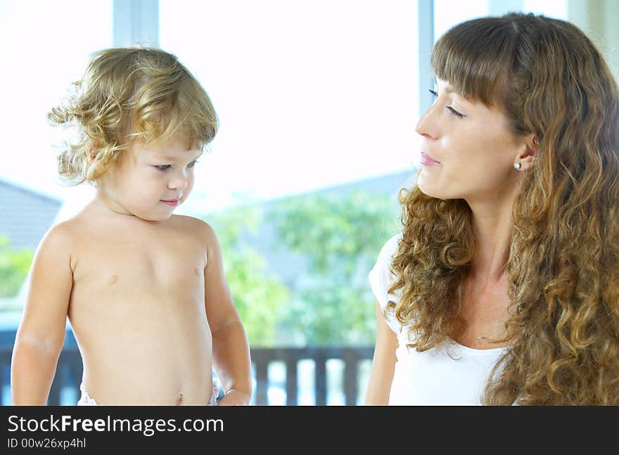 High key portrait of happy mother with baby. High key portrait of happy mother with baby