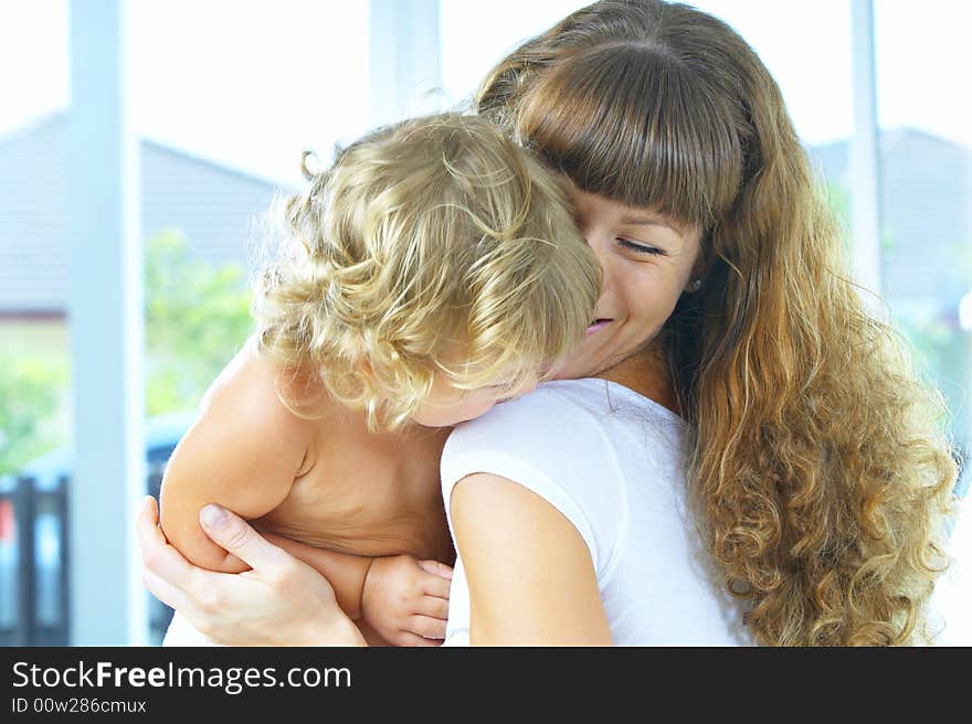 High key portrait of happy mother with baby. High key portrait of happy mother with baby