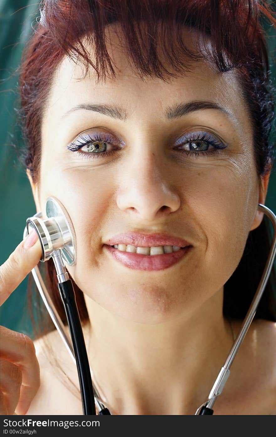 Young woman examining herself by using a stethoscope. Young woman examining herself by using a stethoscope