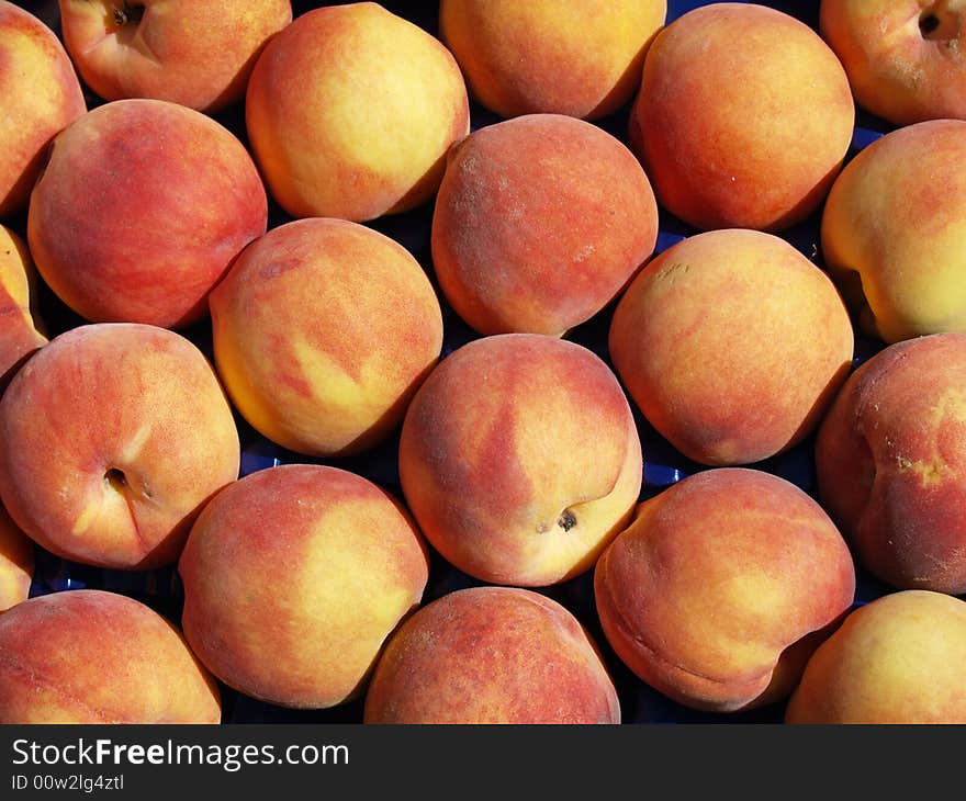 Rows of peaches as a background on sunny market day. Rows of peaches as a background on sunny market day