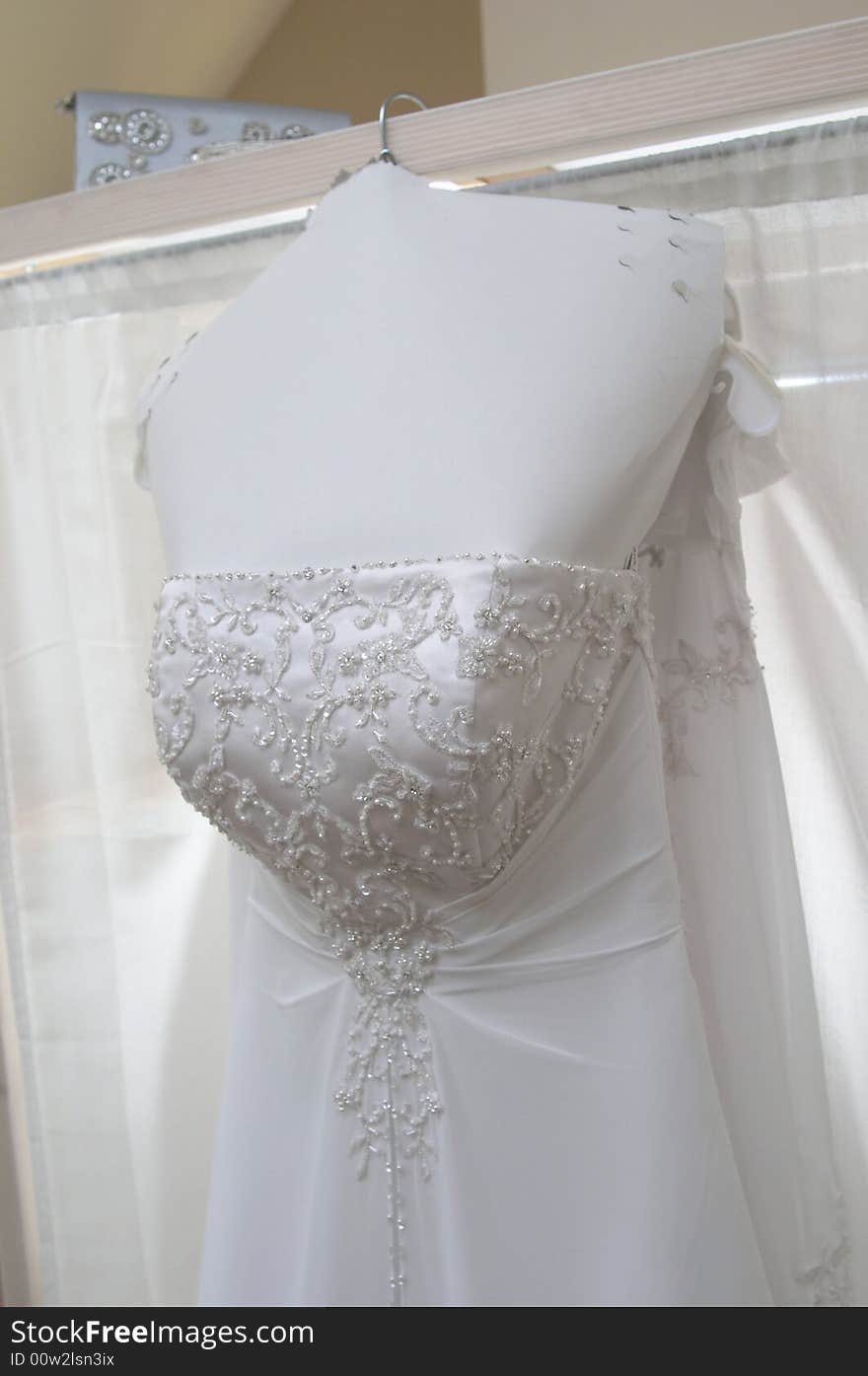 White wedding gown hanging in bridal suite