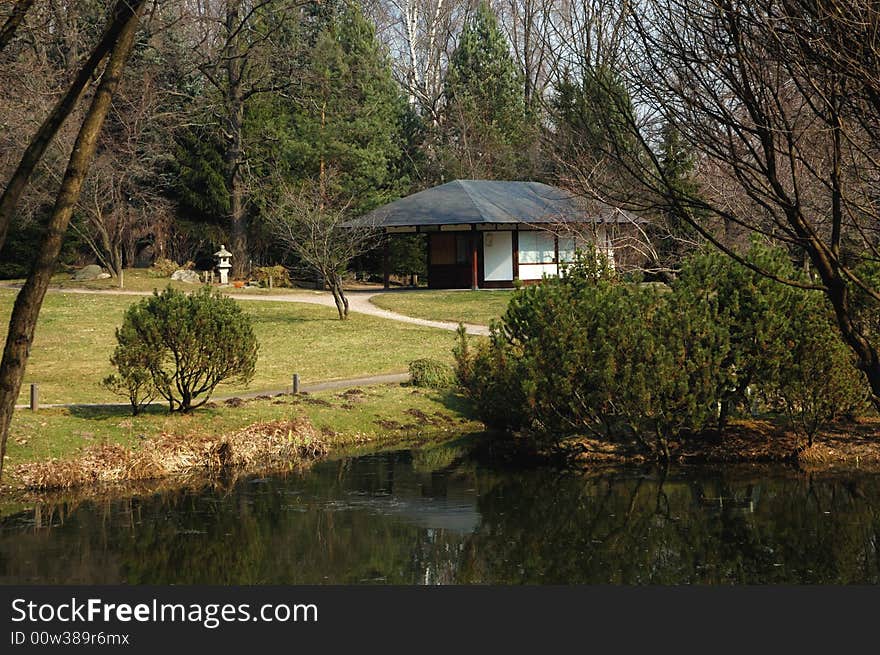 Japanese garden with tea room and a pond in early spring