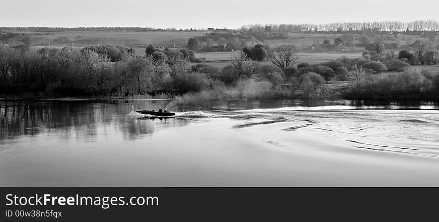 Image illustrating active relaxation: fishing and swimming with the motor boat in the countryside