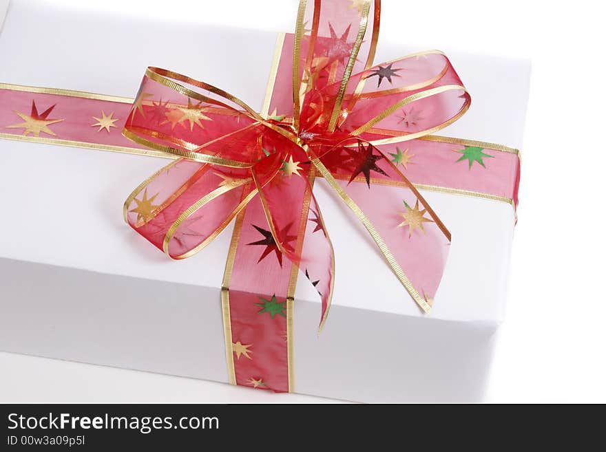 White box wrapped in red bow and ribbon. White box wrapped in red bow and ribbon