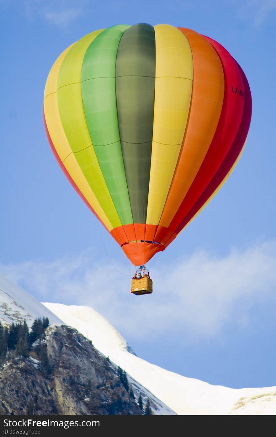 Colorful hot air balloon glides in the blue sky. Colorful hot air balloon glides in the blue sky