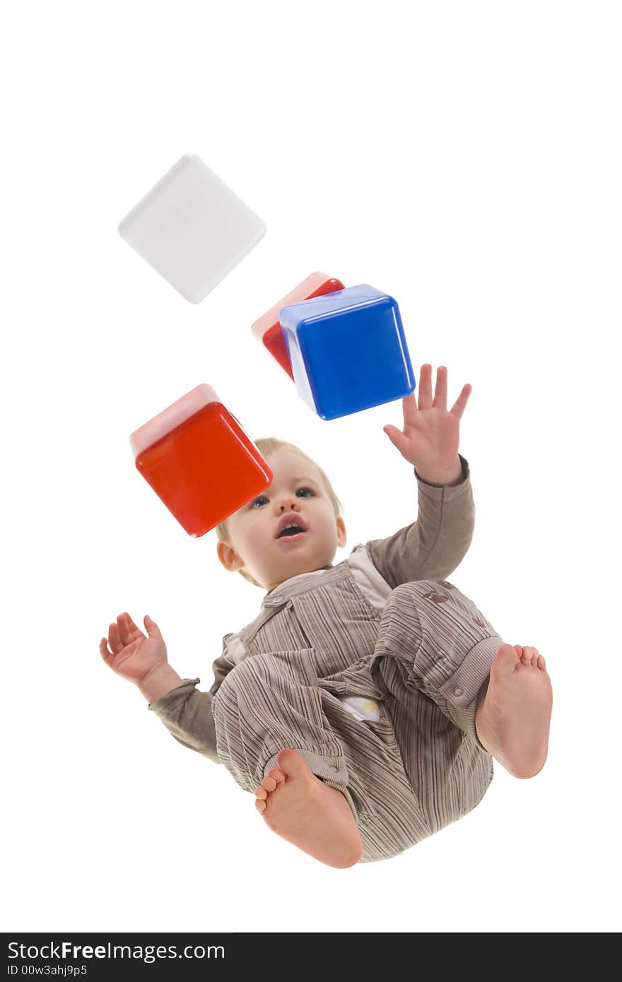 A baby boy squat and playing with blocks. Isolated on white background. Unusual angle view - directly below. A baby boy squat and playing with blocks. Isolated on white background. Unusual angle view - directly below.