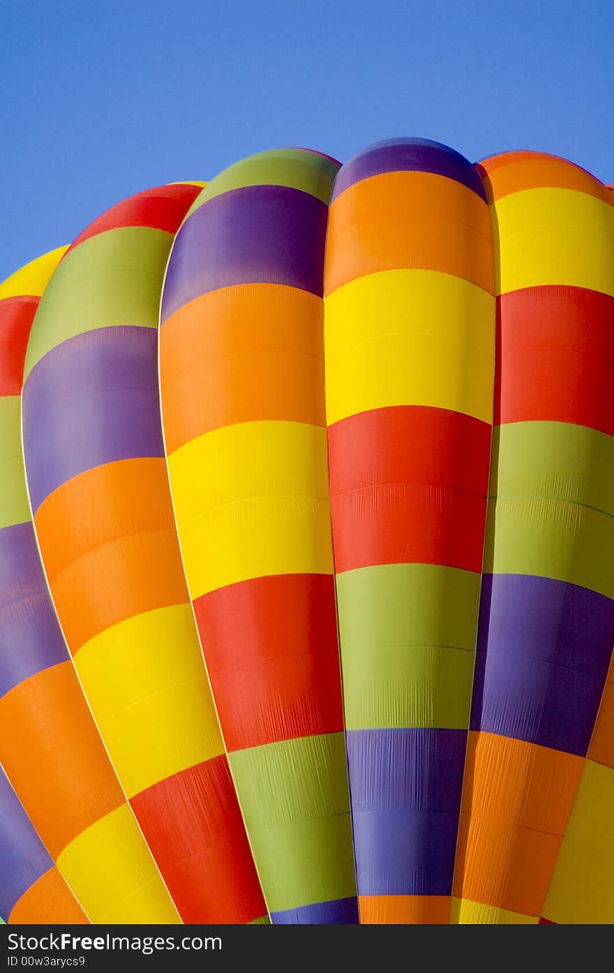 Colorful hot air balloon glides in the blue sky. Colorful hot air balloon glides in the blue sky