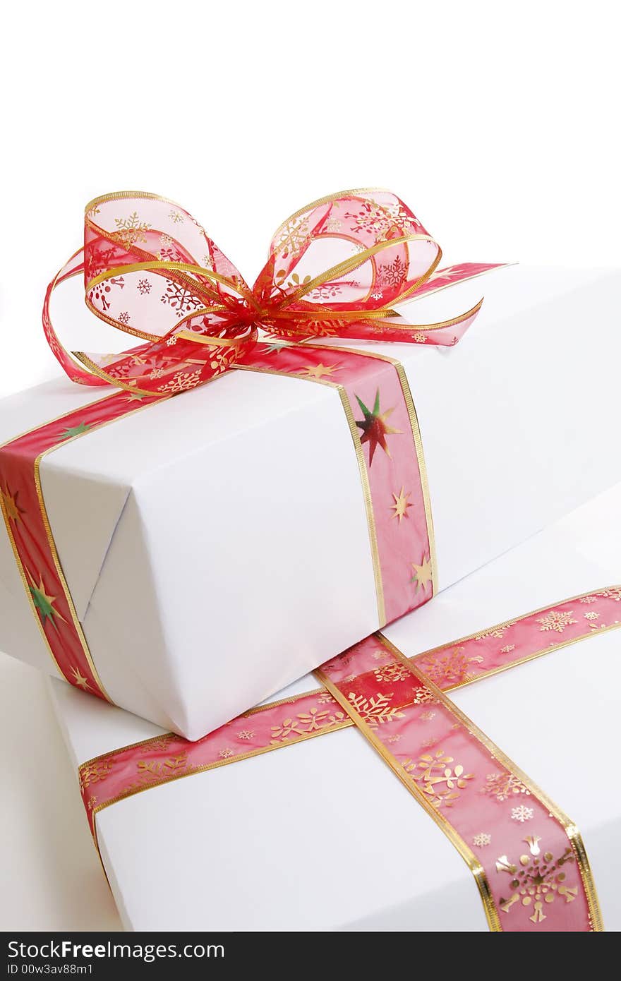 White box wrapped in red bow and ribbon. White box wrapped in red bow and ribbon