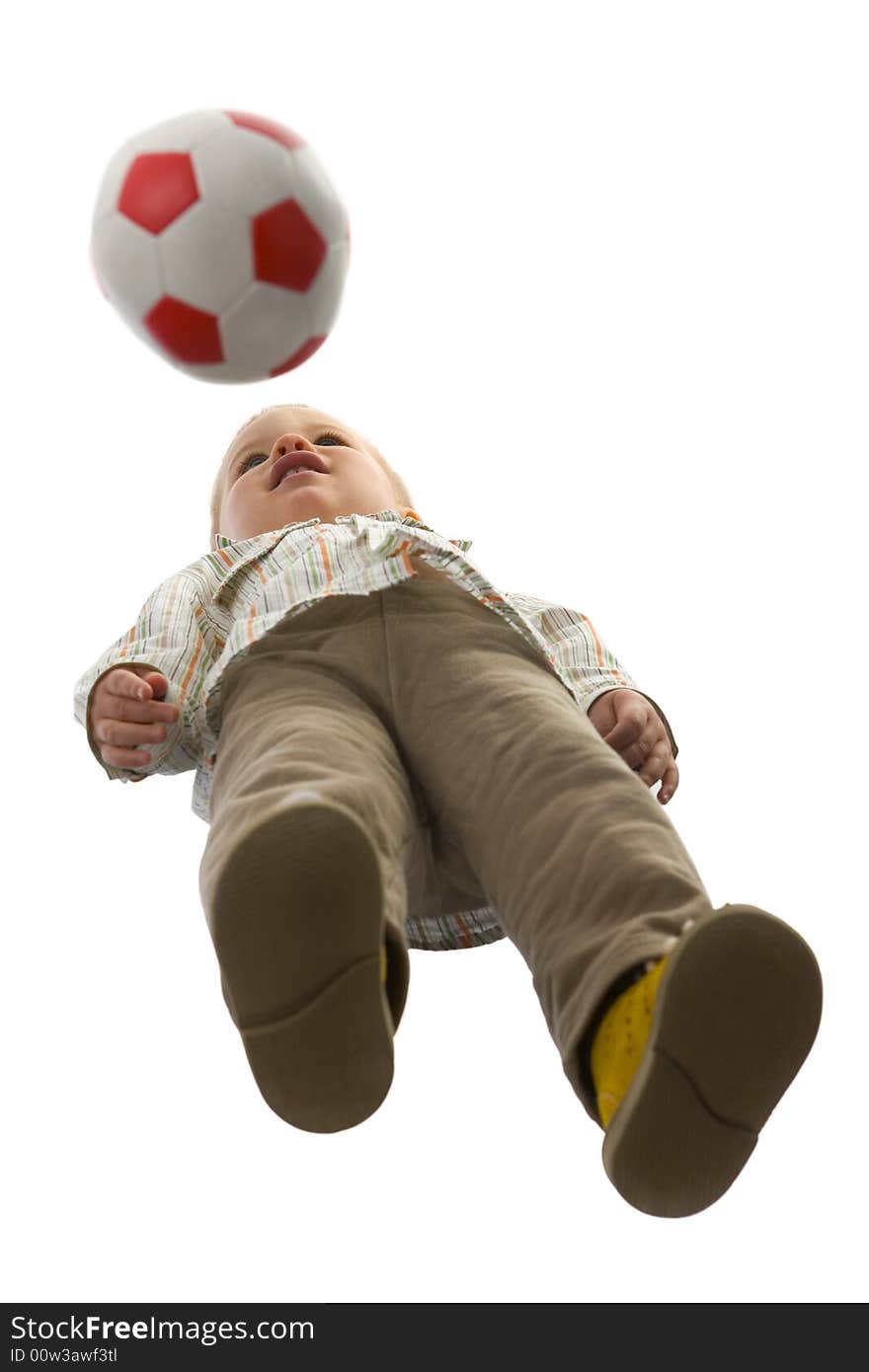 Baby boy standing with ball. Isolated on white background. Unusual angle view - directly below. Baby boy standing with ball. Isolated on white background. Unusual angle view - directly below.