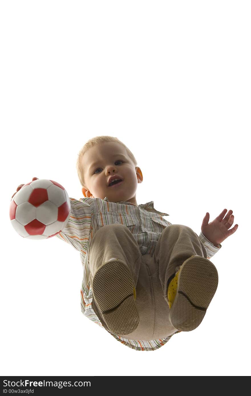 Baby boy squatting and holding ball. Looking at camera. Isolated on white background. Unusual angle view - directly below. Baby boy squatting and holding ball. Looking at camera. Isolated on white background. Unusual angle view - directly below.