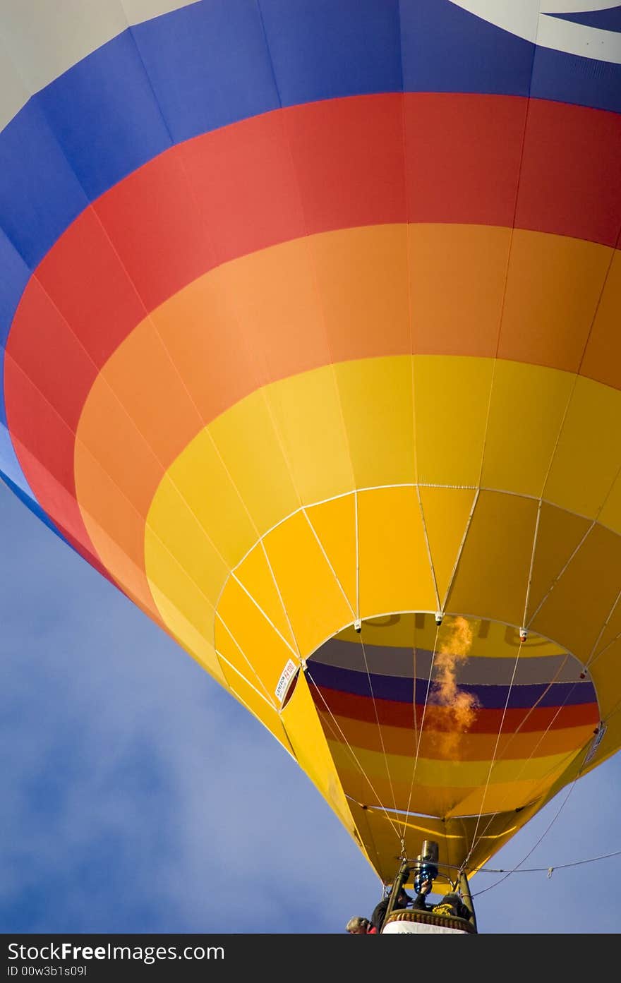 Colorful hot air balloon glides in the blue sky. Colorful hot air balloon glides in the blue sky