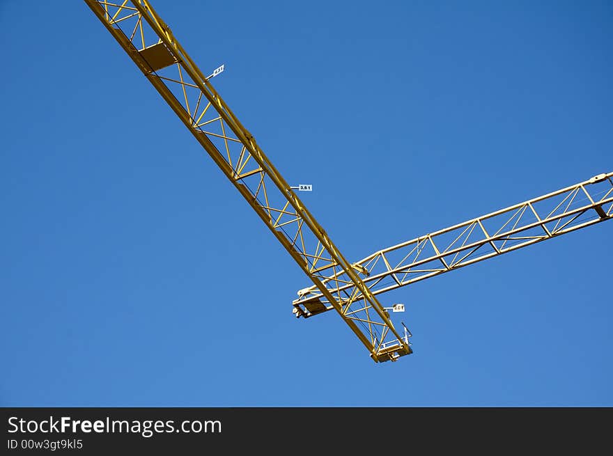 Yellow cranes against on the blue sky. Yellow cranes against on the blue sky