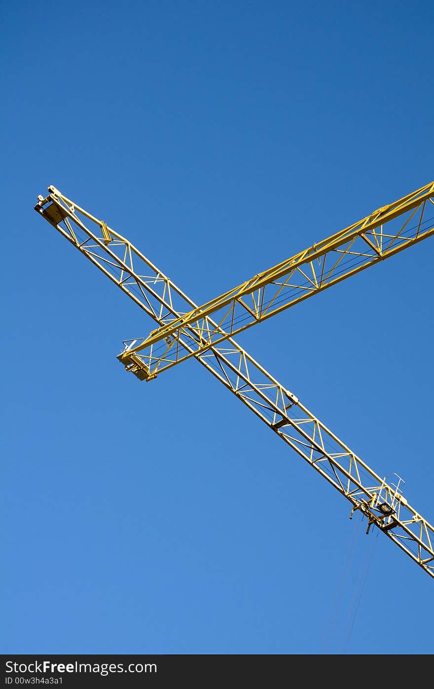 Yellow cranes against on the blue sky. Yellow cranes against on the blue sky