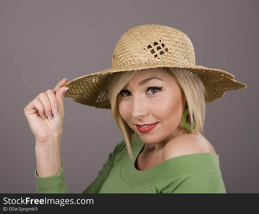 Blonde in Straw Hat Holding Brim