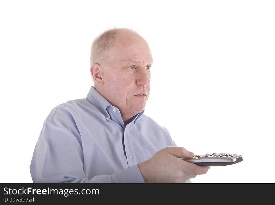 An older guy in a blue dress shirt working a remote control toward copy space. An older guy in a blue dress shirt working a remote control toward copy space