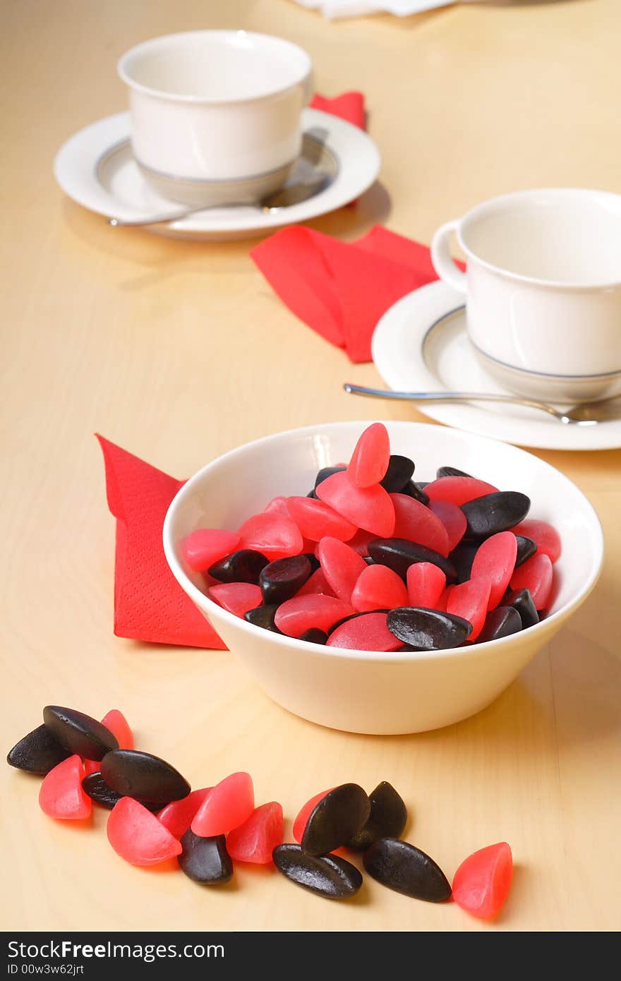 Candy with coffee cups in the background. Candy with coffee cups in the background