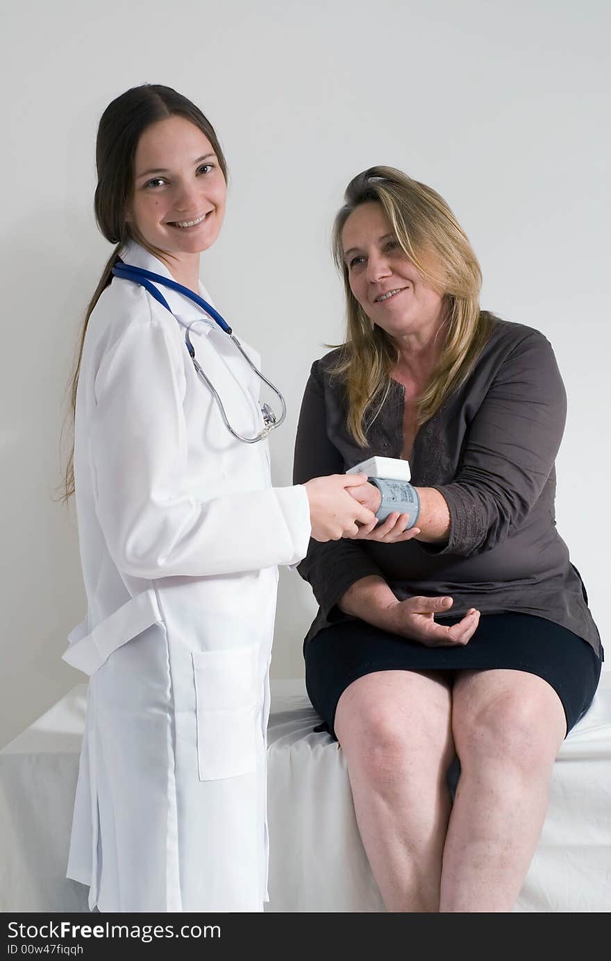 Older female patient being examined by a younger female doctor. Older female patient being examined by a younger female doctor