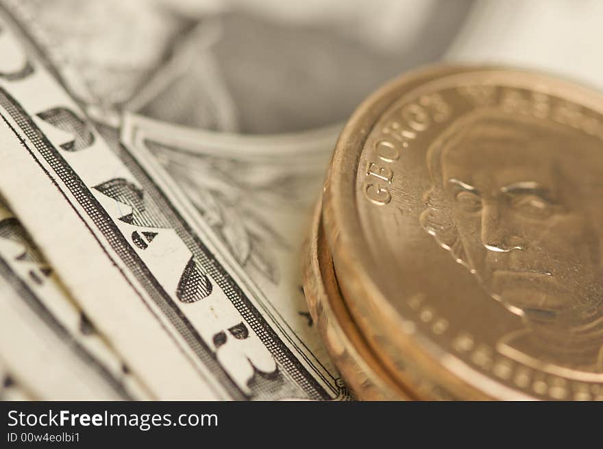 Close-up Abstract of the new U.S. Dollar coin on Dollar Bills with Narrow Depth of Field. Close-up Abstract of the new U.S. Dollar coin on Dollar Bills with Narrow Depth of Field.