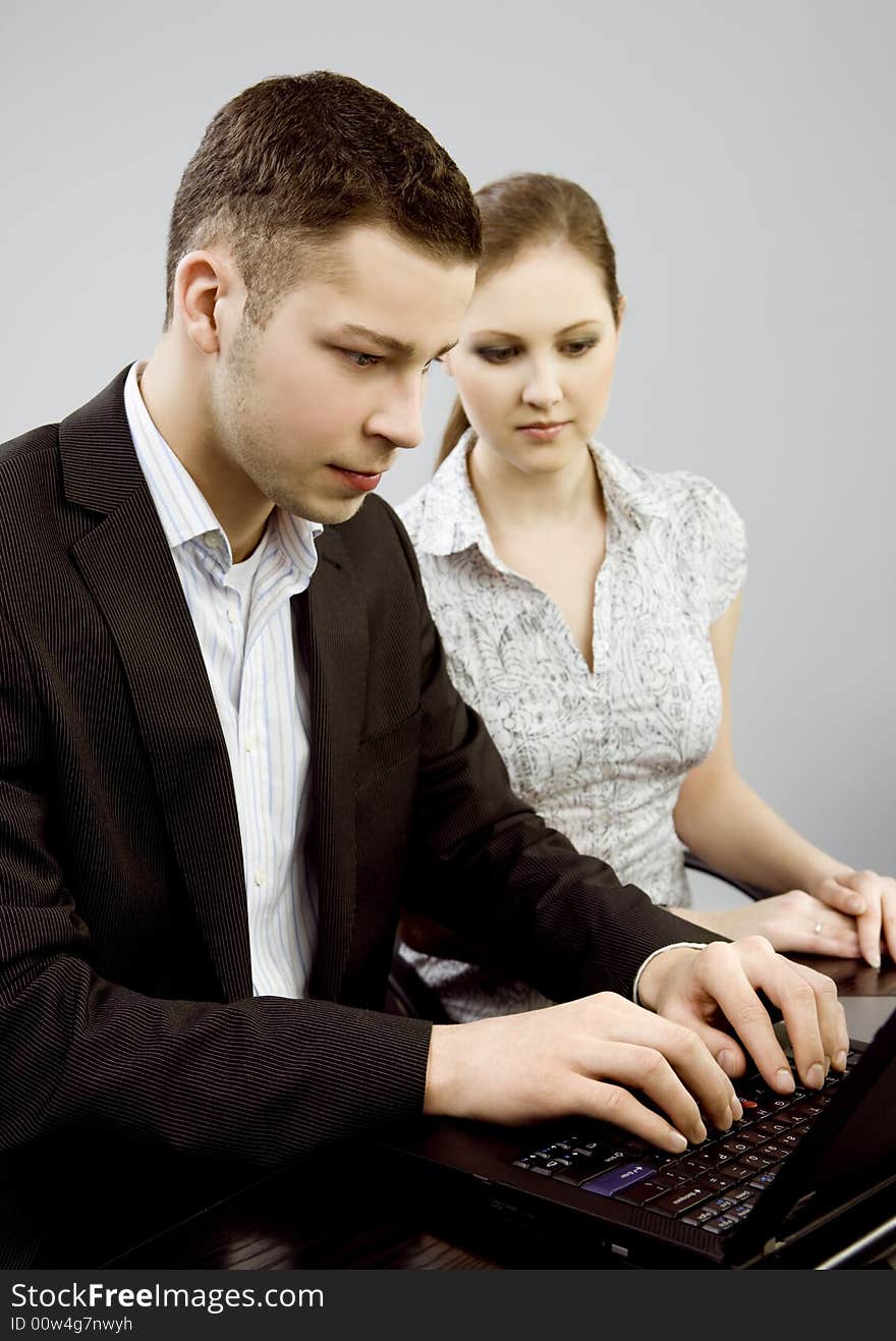 Business couple portrait - young man and woman working together. Business couple portrait - young man and woman working together