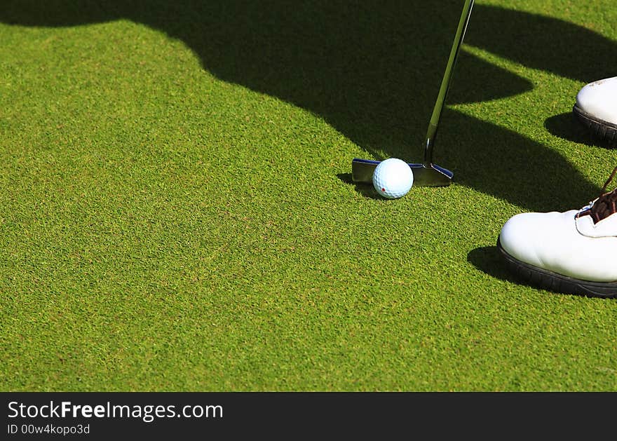 Top view of golfer in the green ready to strike the golf ball