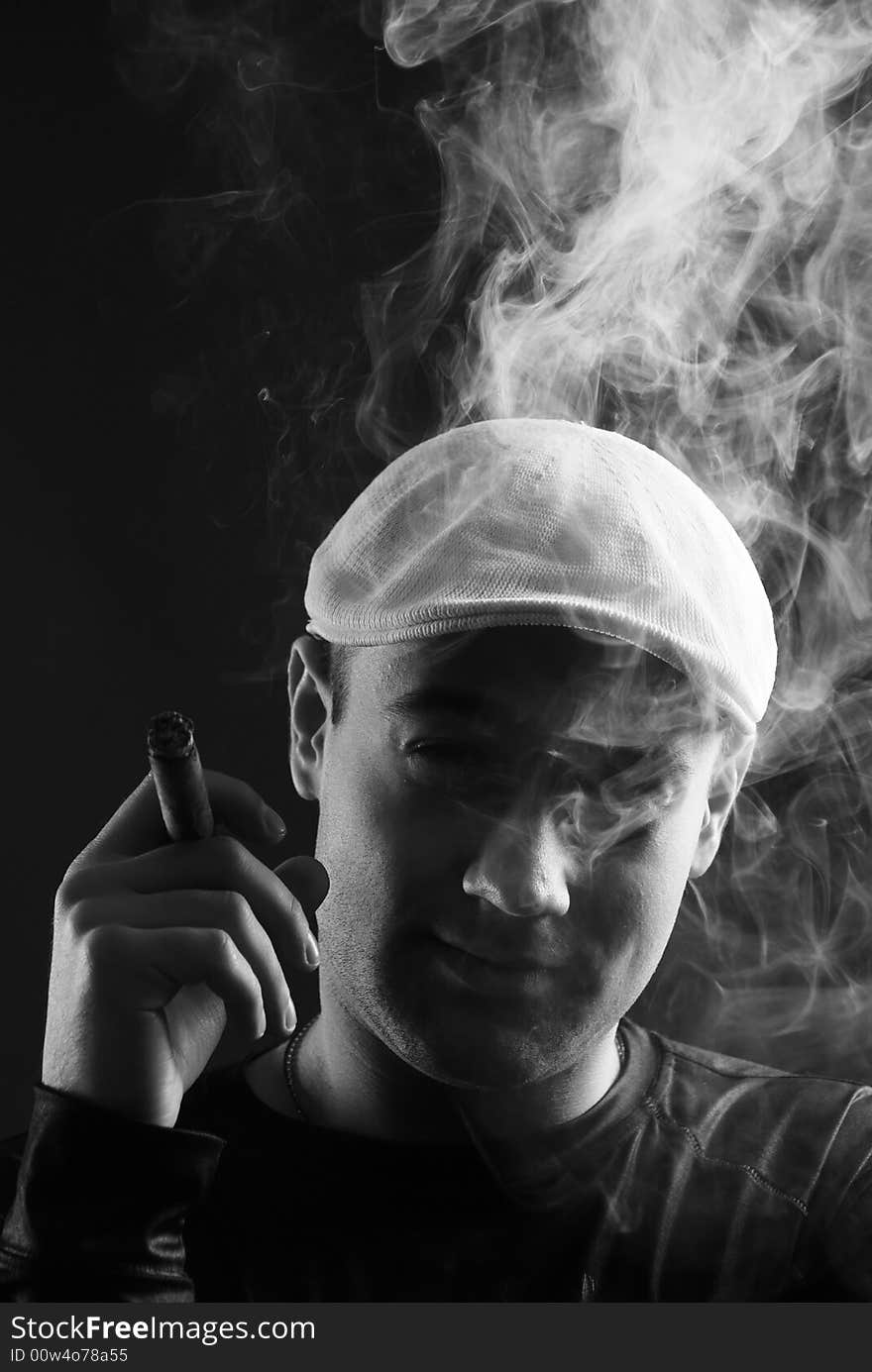 Man with cigare at black background