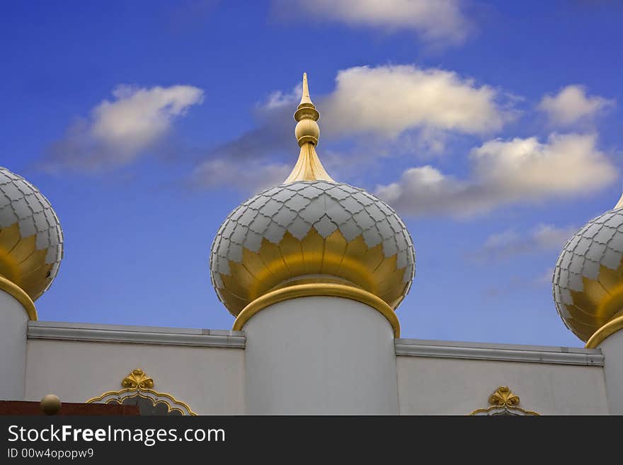 Taj Mahal Dome with white and gold on a deep blue sky with clouds. Taj Mahal Dome with white and gold on a deep blue sky with clouds