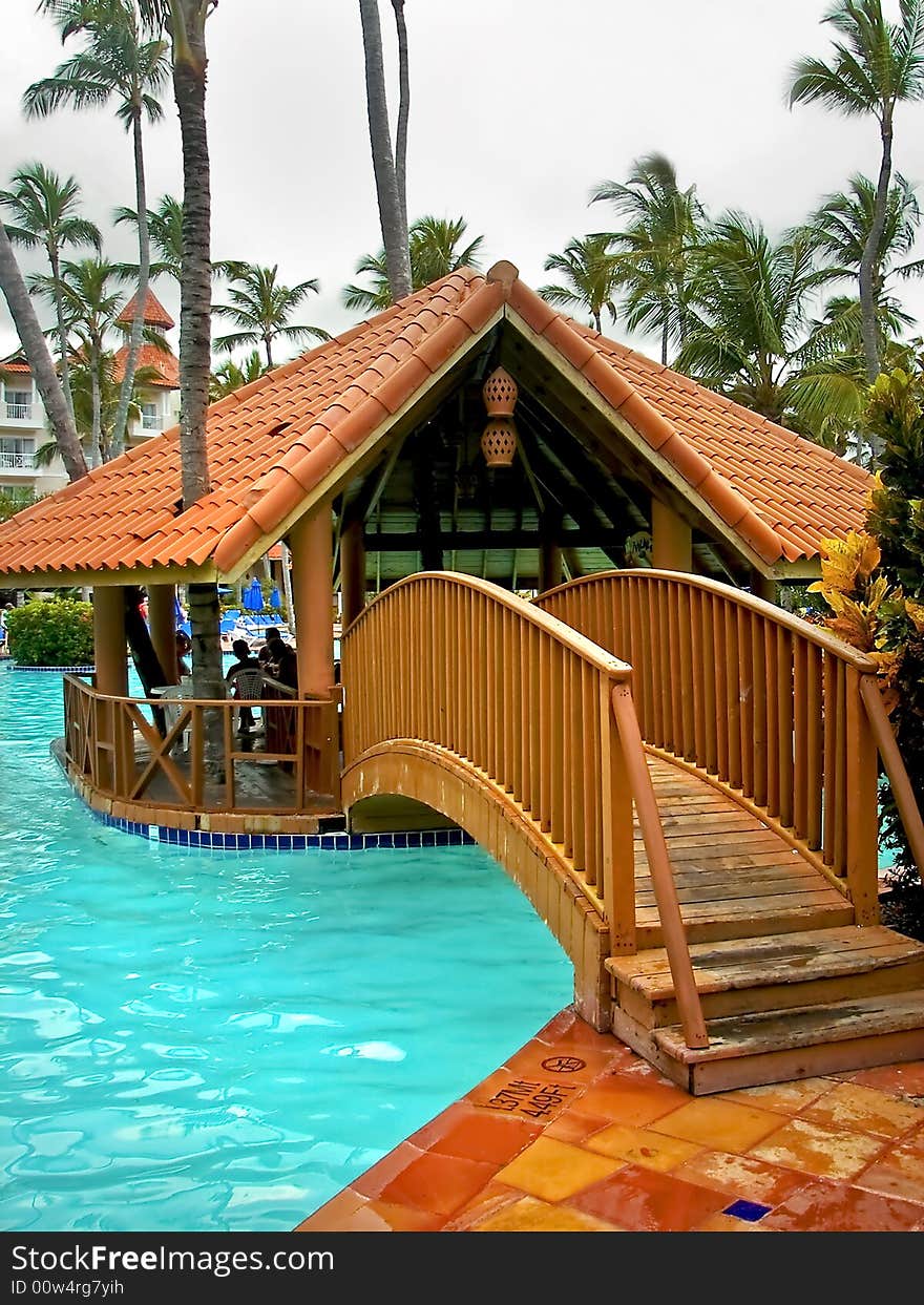 Small hut that is in the middle of a large swimming pool on a nice tropical resort. Small hut that is in the middle of a large swimming pool on a nice tropical resort.