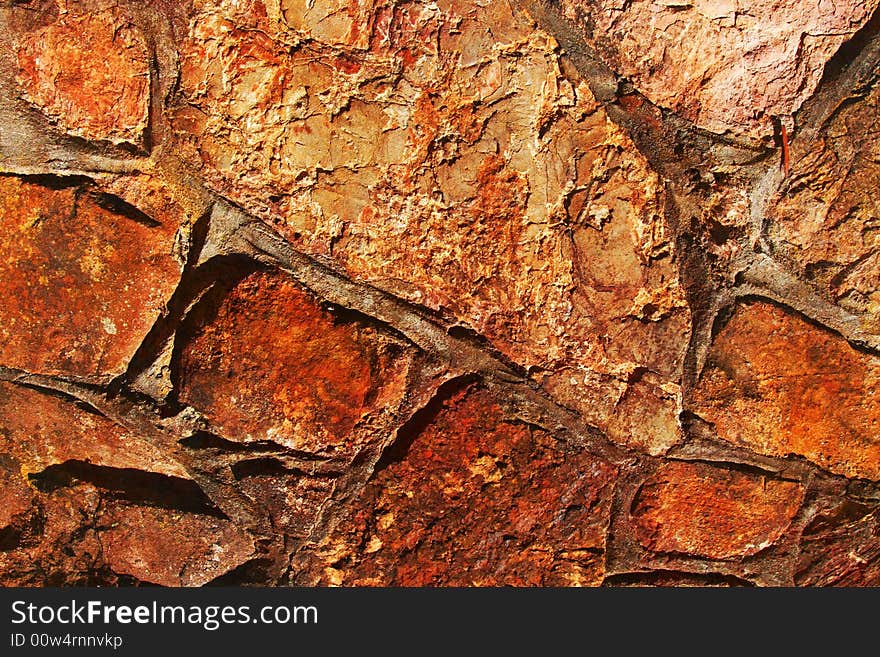 Old stone wall with rusty texture in earthy colors