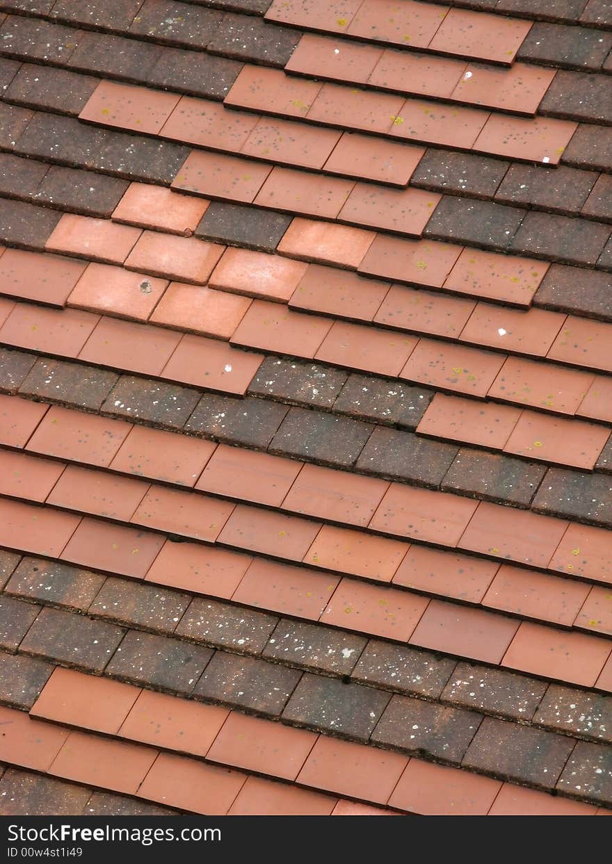 Roof made up of different colored roof tiles. Roof made up of different colored roof tiles