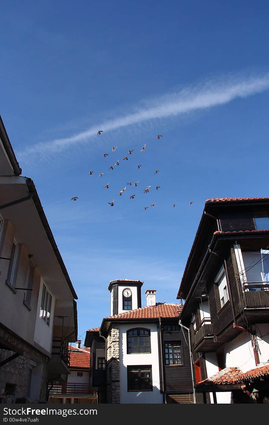 Pigeons flight over old town Nesebar in Bulgaria