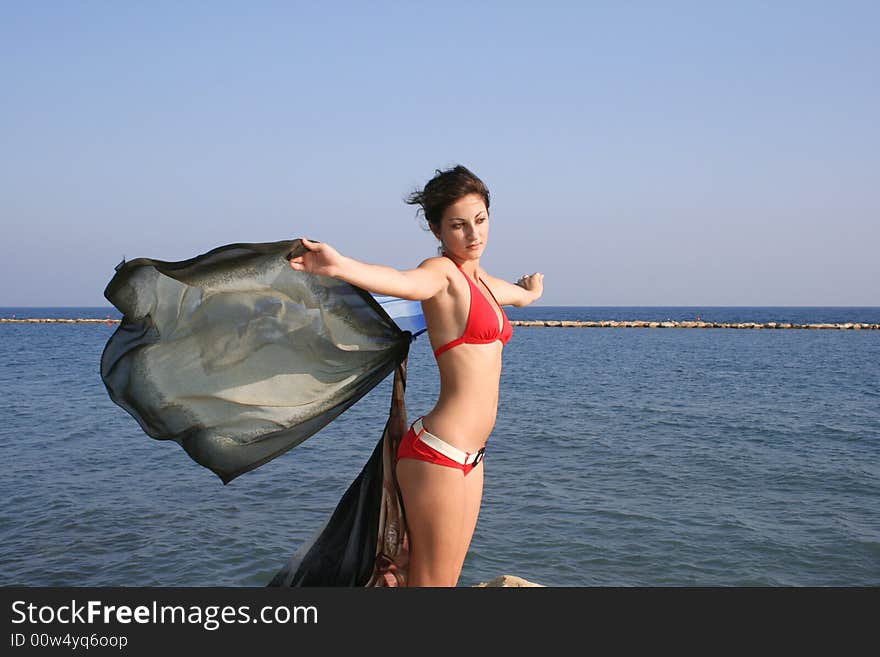 Pretty girl with pareo on the beach.