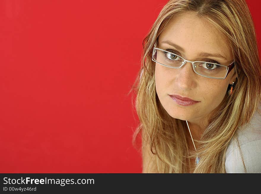 Attractive woman look to the camera on the red background. Attractive woman look to the camera on the red background