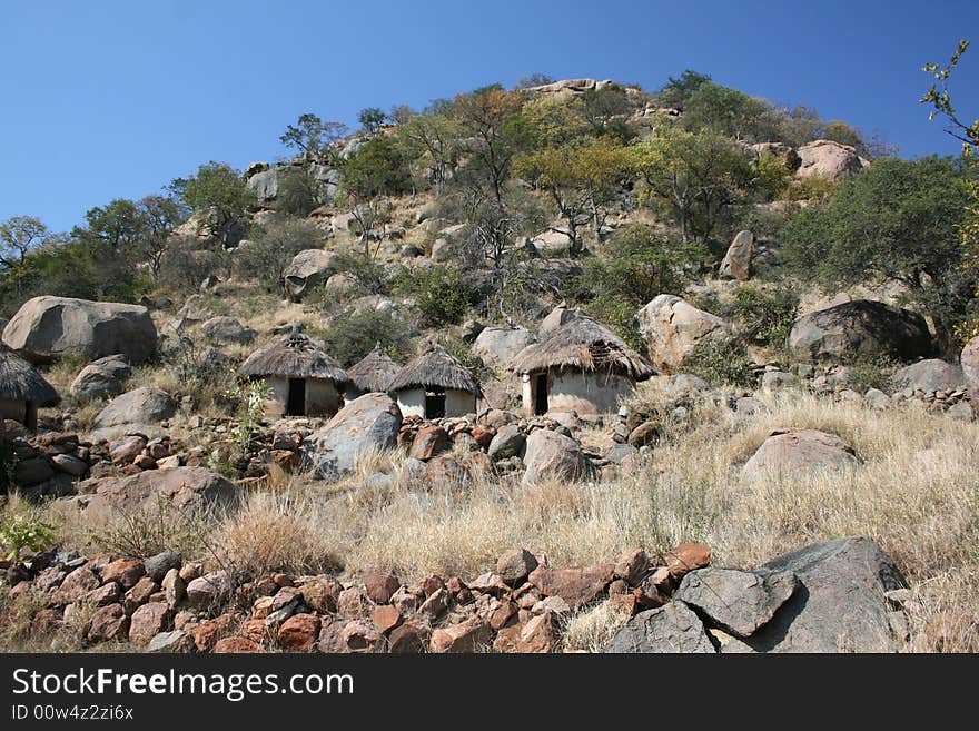 African Tribal Settlement at the foot of a granite hill.