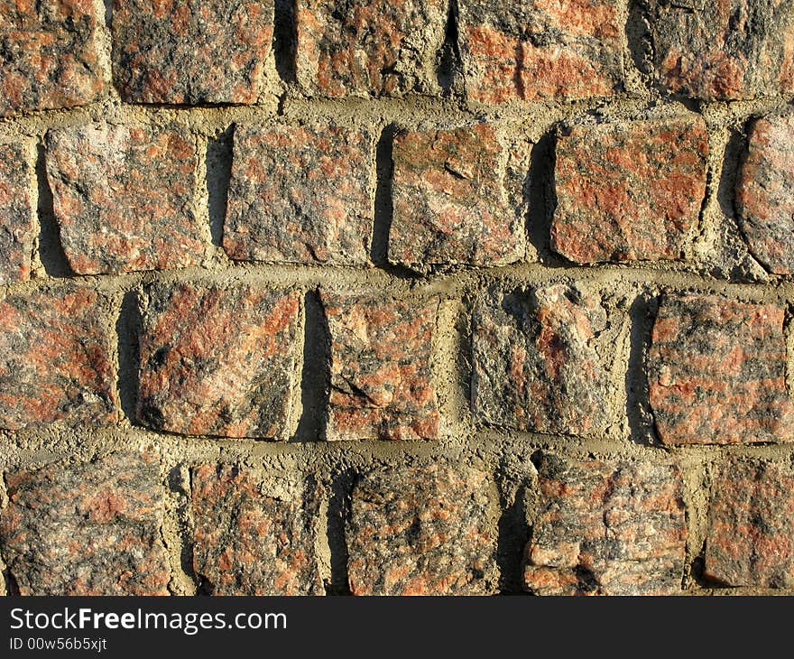 Rough red granite wall texture. Rough red granite wall texture