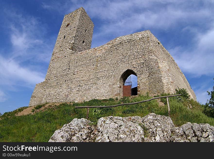 Historical castle in mountains with blue sky