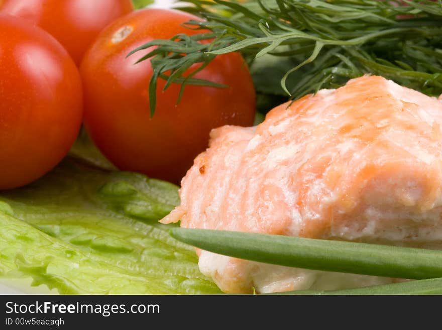 Stake from a salmon with vegetables on a plate