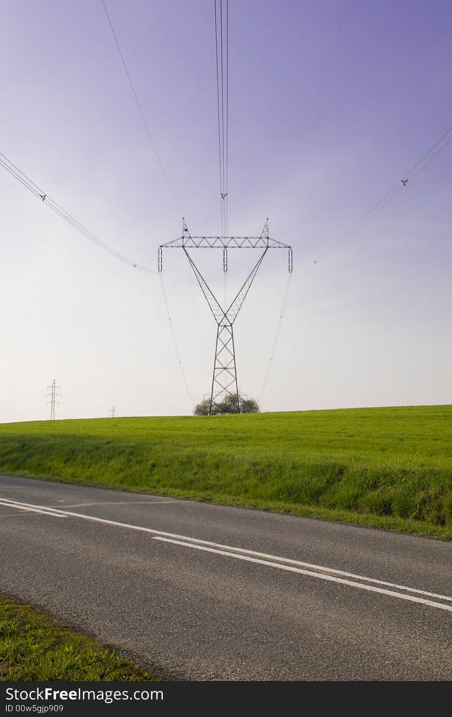 Silhouette of the electricity pylon with cables and the blue sky