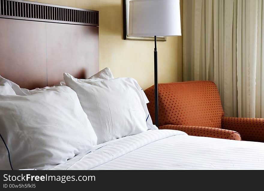 Comfortable bed with fresh white linens in hotel room. Comfortable bed with fresh white linens in hotel room