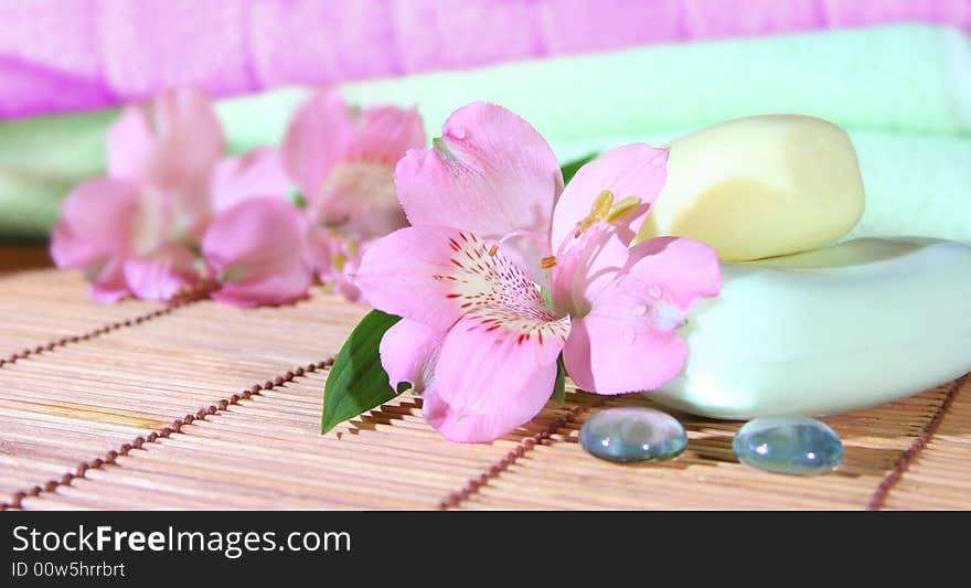 Soap, towels and pink flowers